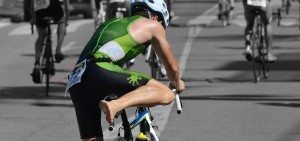 triathlete mounting a bike