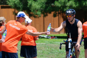 triathlete at aid station