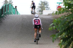 krista climbing on bike vineman